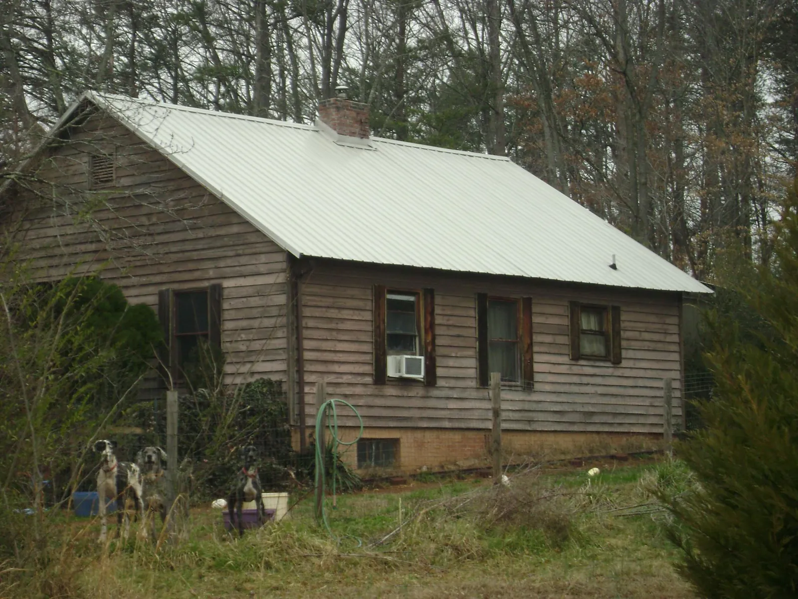 White metal roof on an old wood sided farmhouse, from a Metal Roof Installation job in Silver Lake
